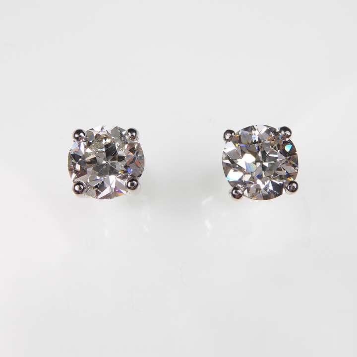 Pair of old round brilliant cut diamond stud earrings